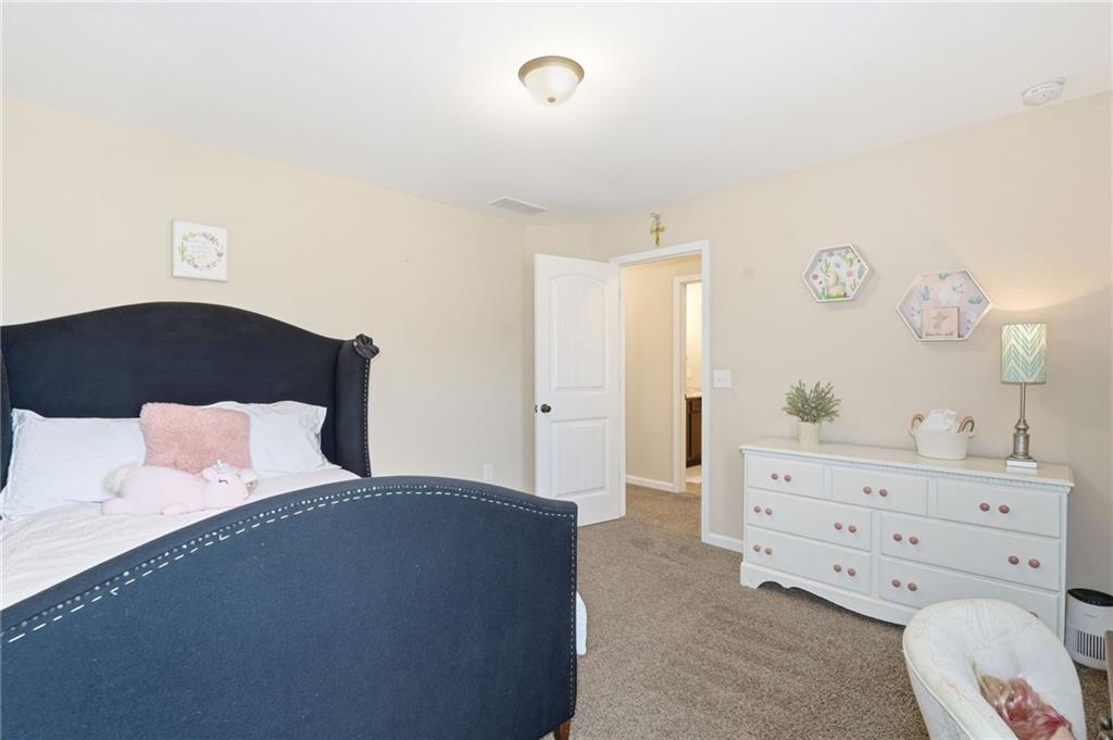 266 Cobblestone Trail Dallas, GA 30132 - Photo 37 of 49 a bedroom with a bed and a dresser