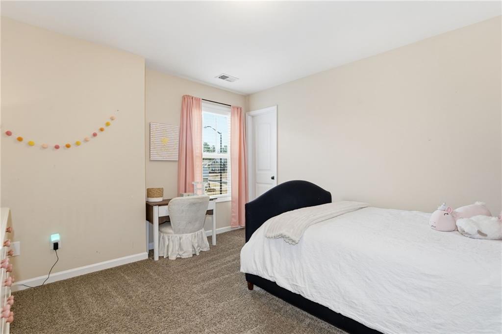 266 Cobblestone Trail Dallas, GA 30132 - Photo 38 of 49 a bedroom with a bed and a window