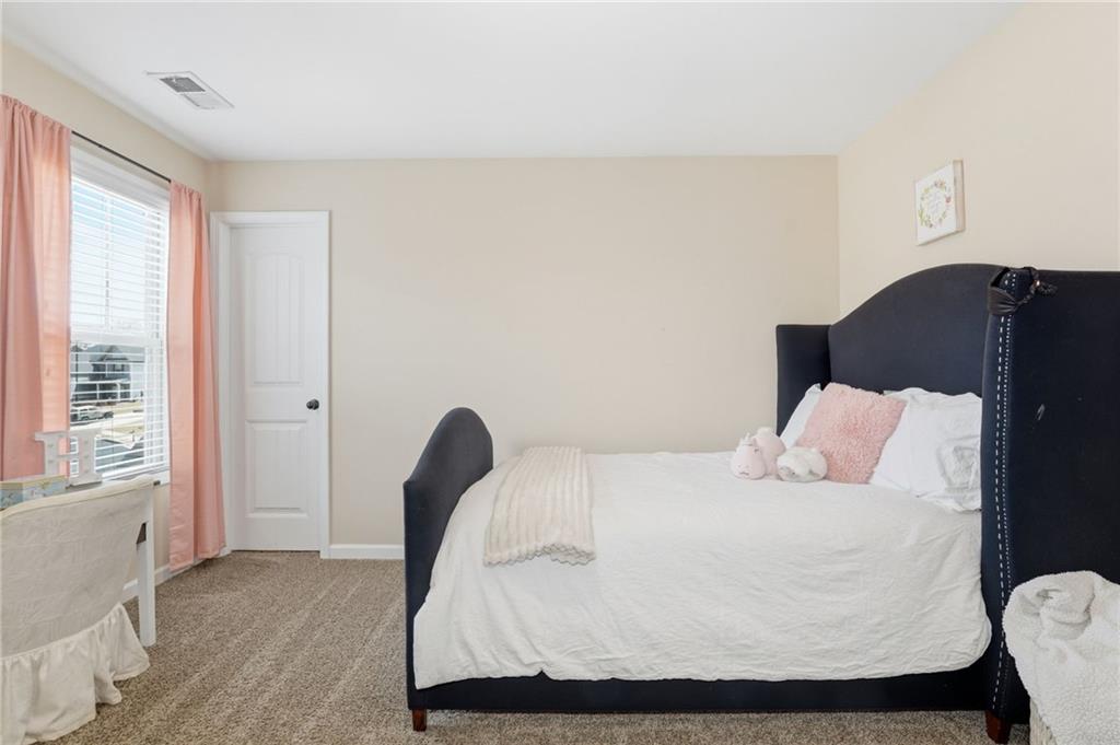 266 Cobblestone Trail Dallas, GA 30132 - Photo 39 of 49 a bedroom with a bed and with a window