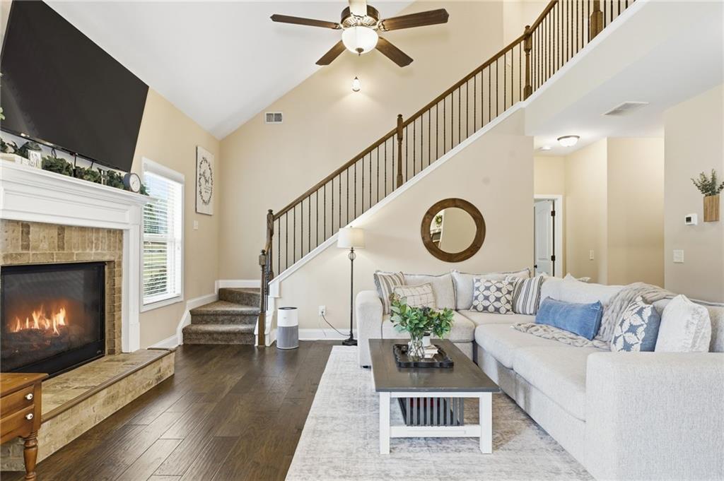 266 Cobblestone Trail Dallas, GA 30132 - Photo 5 of 49 a living room with furniture a fireplace and a flat screen tv