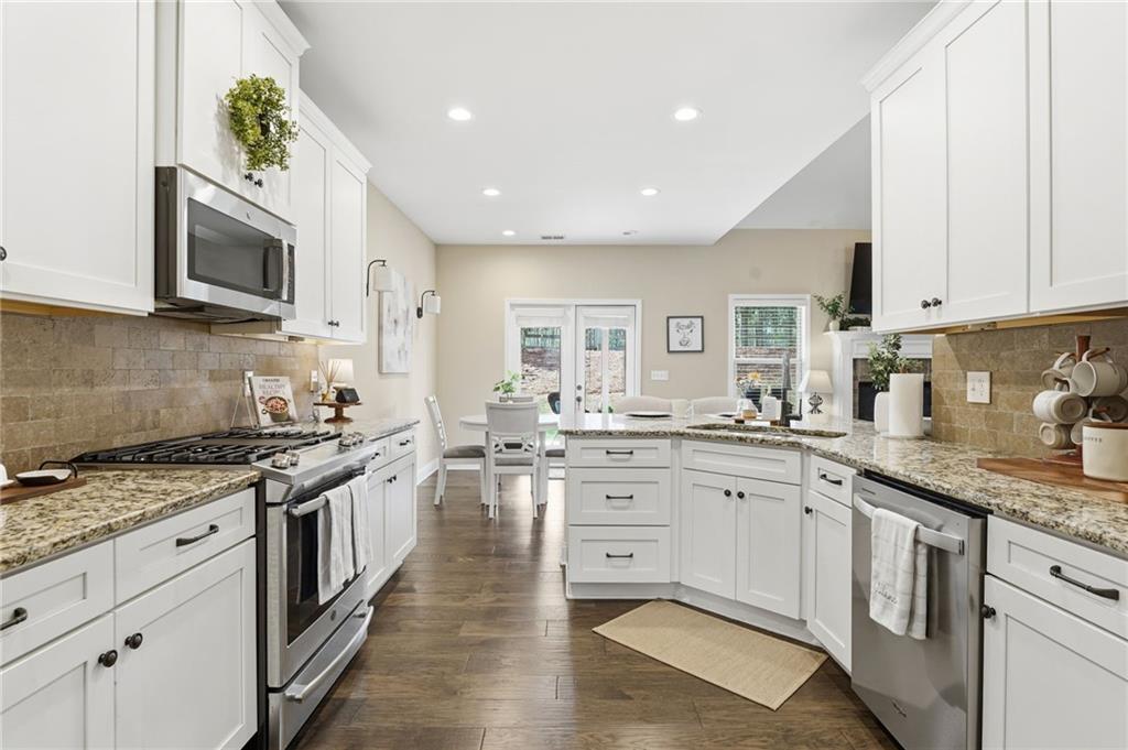 266 Cobblestone Trail Dallas, GA 30132 - Photo 8 of 49 a kitchen with stainless steel appliances granite countertop a sink and stove top oven