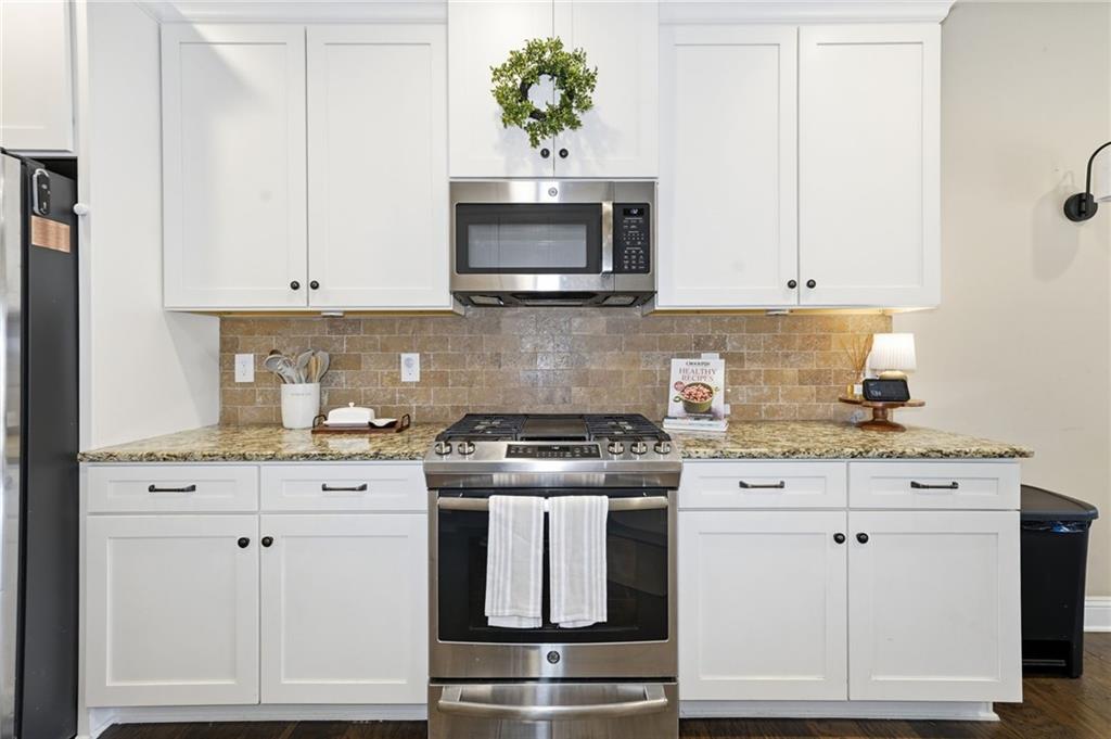 266 Cobblestone Trail Dallas, GA 30132 - Photo 10 of 49 a kitchen with granite countertop white cabinets and stainless steel appliances