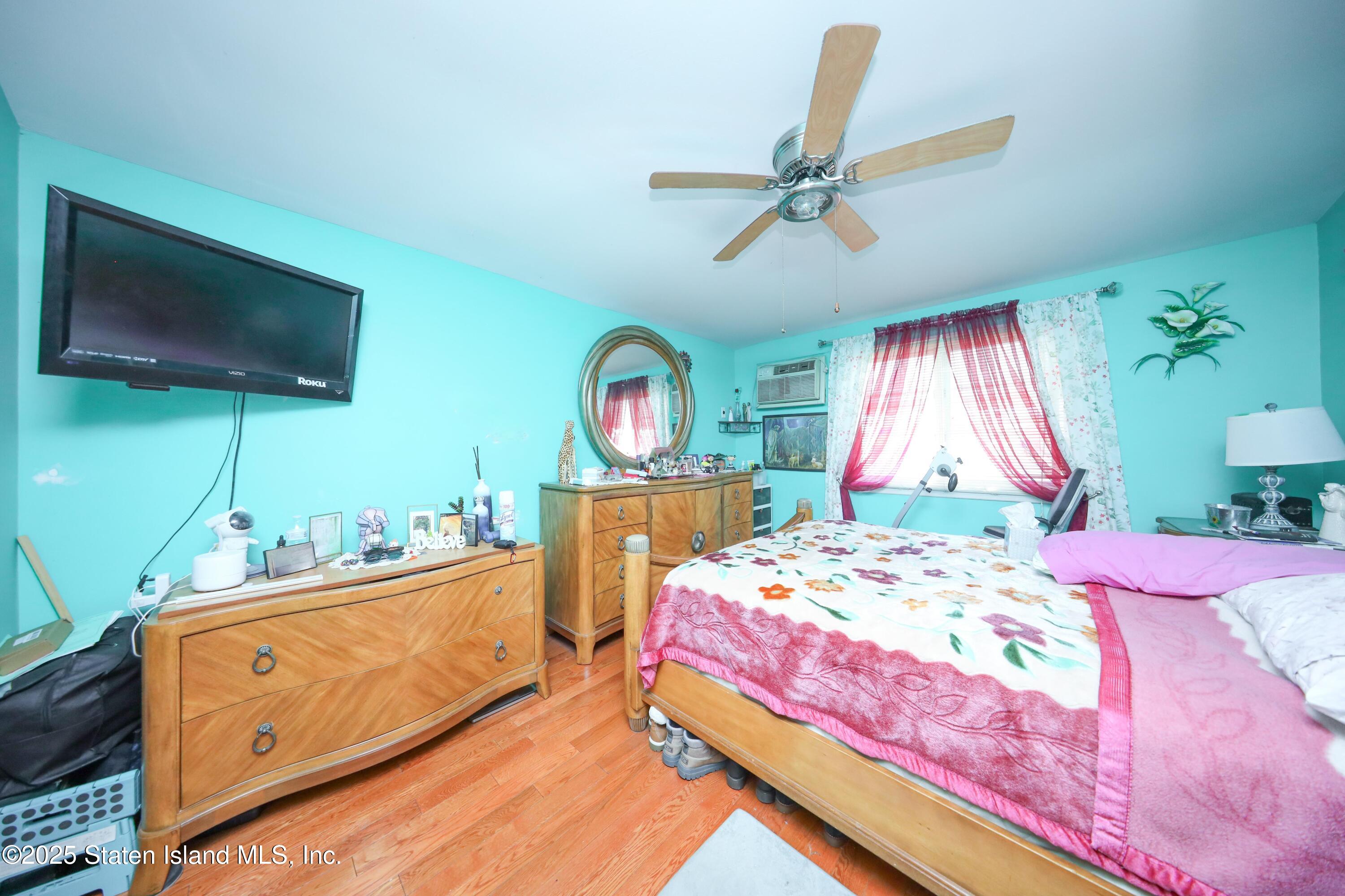 268 Ada Drive Staten Island, NY 10314 - Photo 12 of 27 a bedroom with a bed a flat screen tv and a dresser