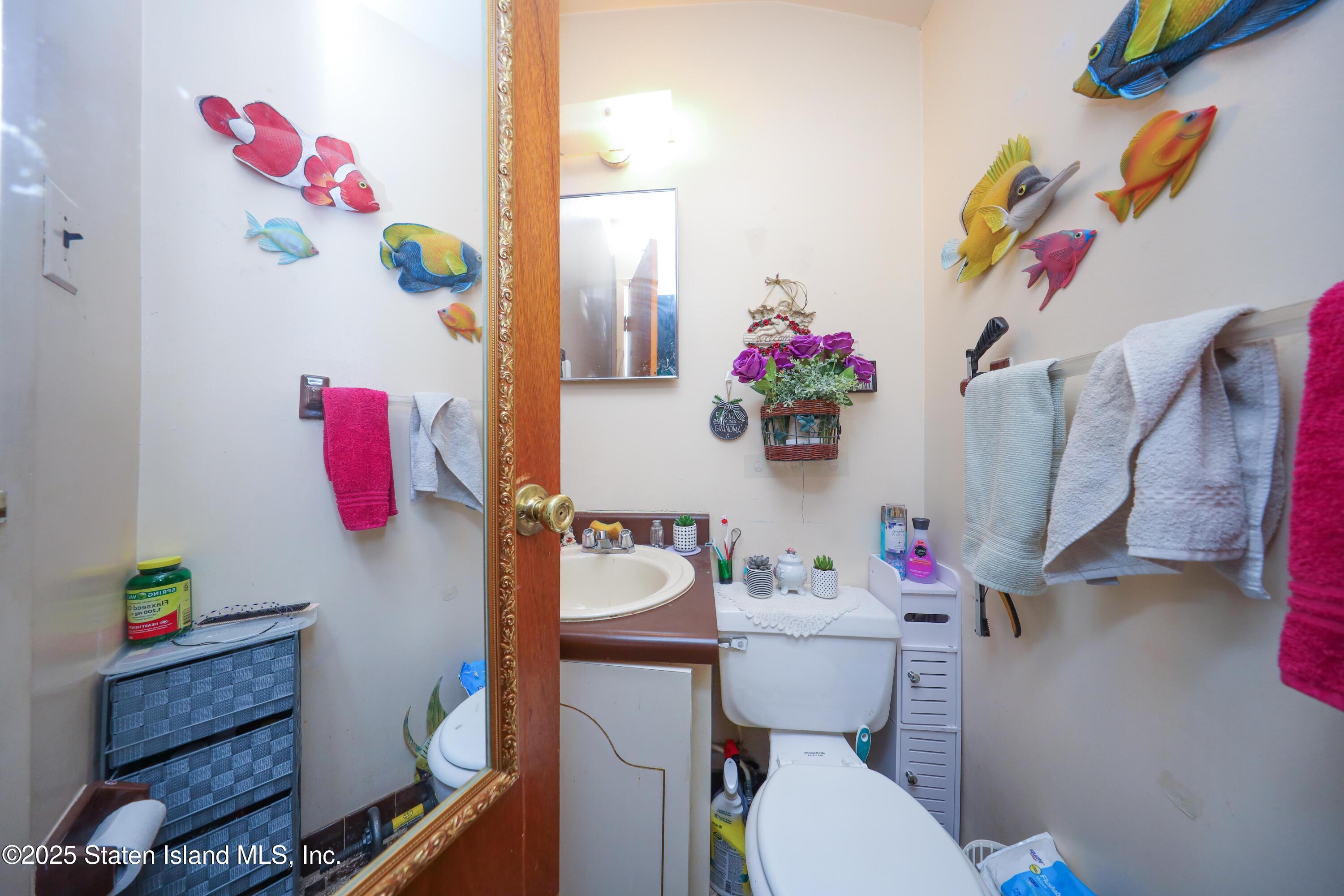 268 Ada Drive Staten Island, NY 10314 - Photo 13 of 27 a bathroom with a sink mirror and toilet