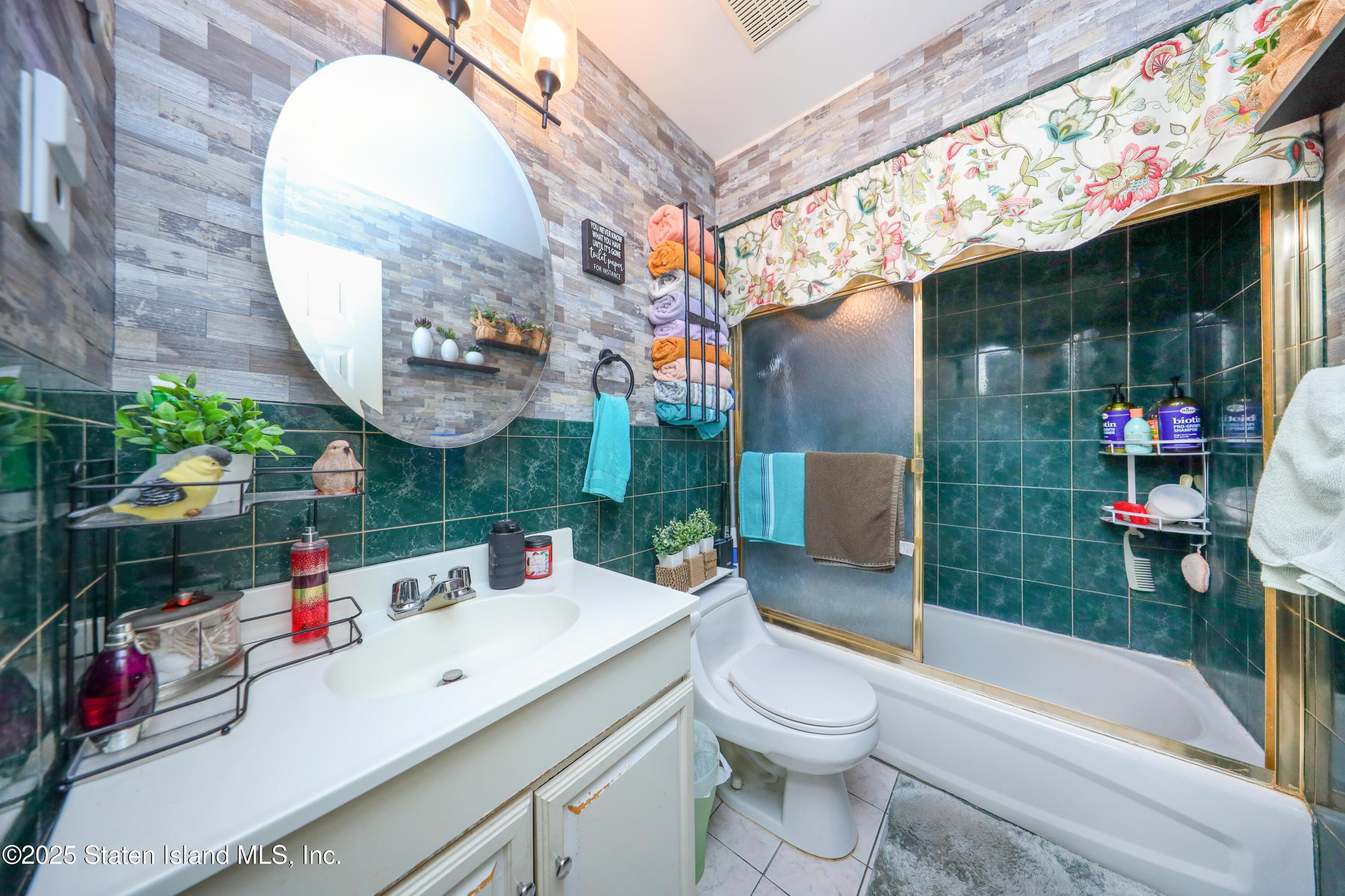 268 Ada Drive Staten Island, NY 10314 - Photo 15 of 27 a bathroom with a sink a toilet and shower