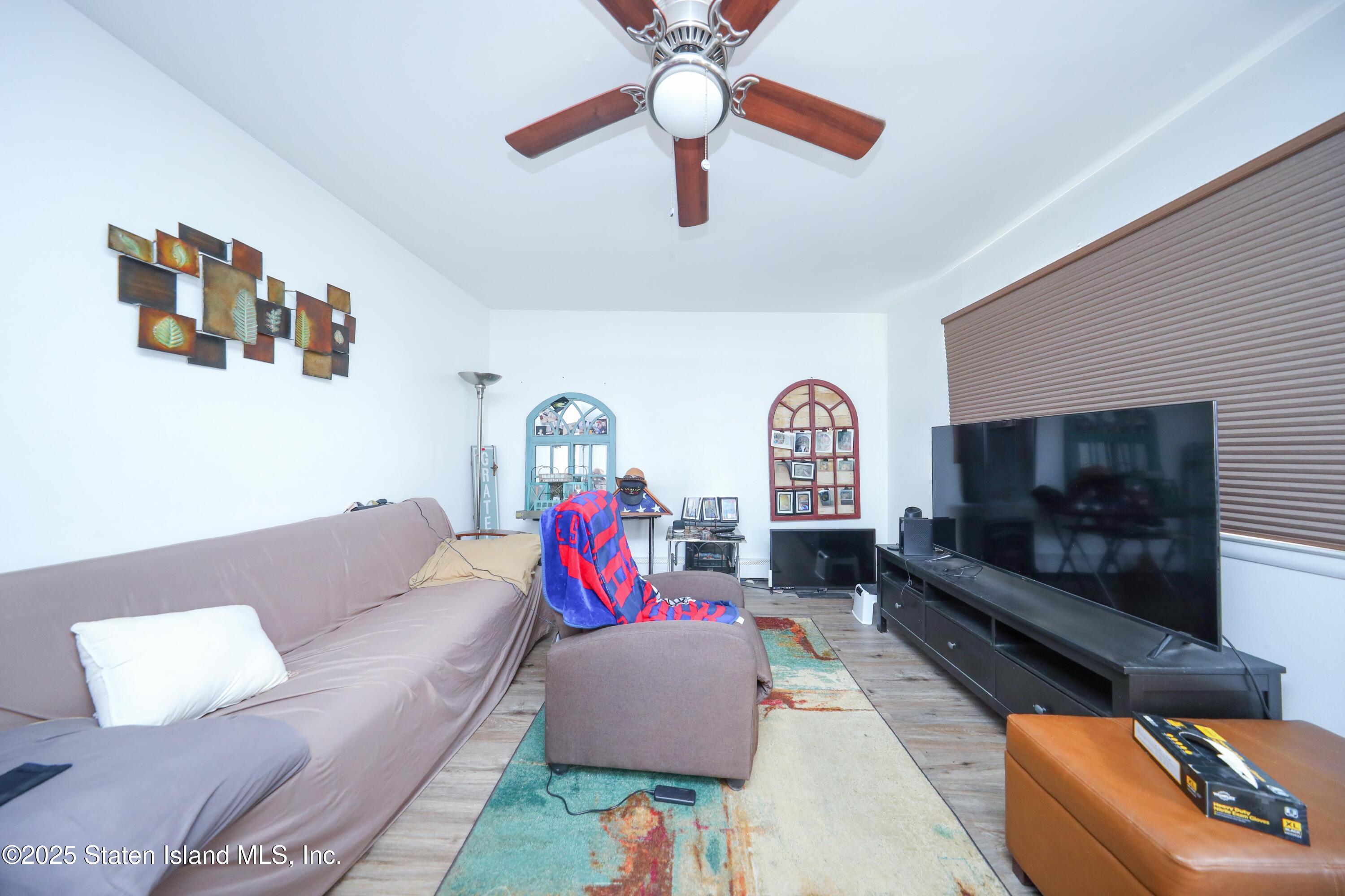 268 Ada Drive Staten Island, NY 10314 - Photo 17 of 27 a living room with furniture and a fireplace