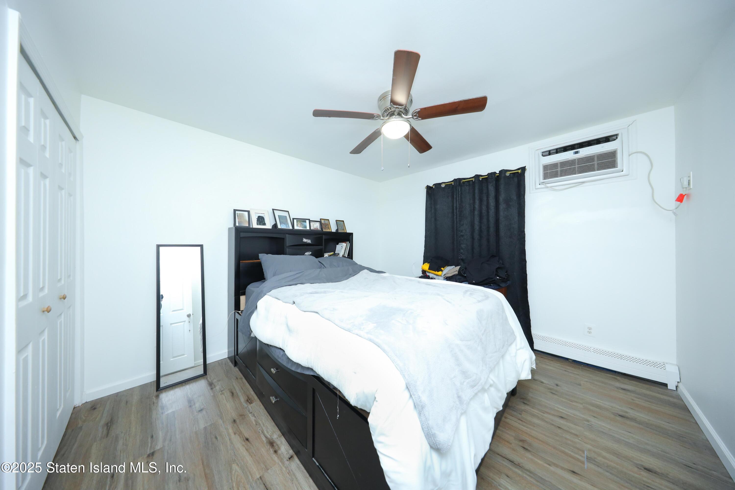 268 Ada Drive Staten Island, NY 10314 - Photo 20 of 27 a bedroom with a bed and wooden floor