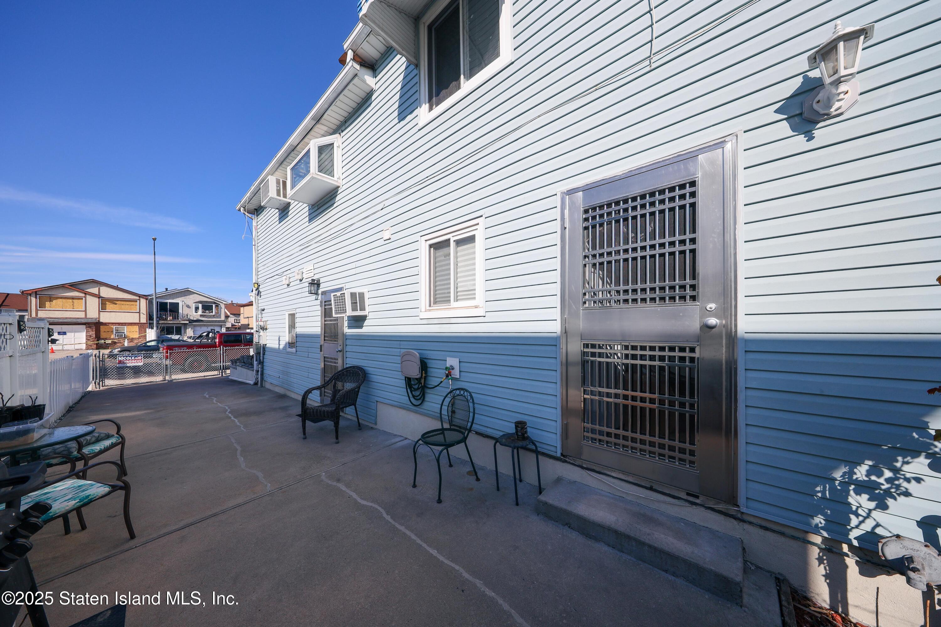 268 Ada Drive Staten Island, NY 10314 - Photo 23 of 27 a view of a patio with couches and table and chairs and potted plants