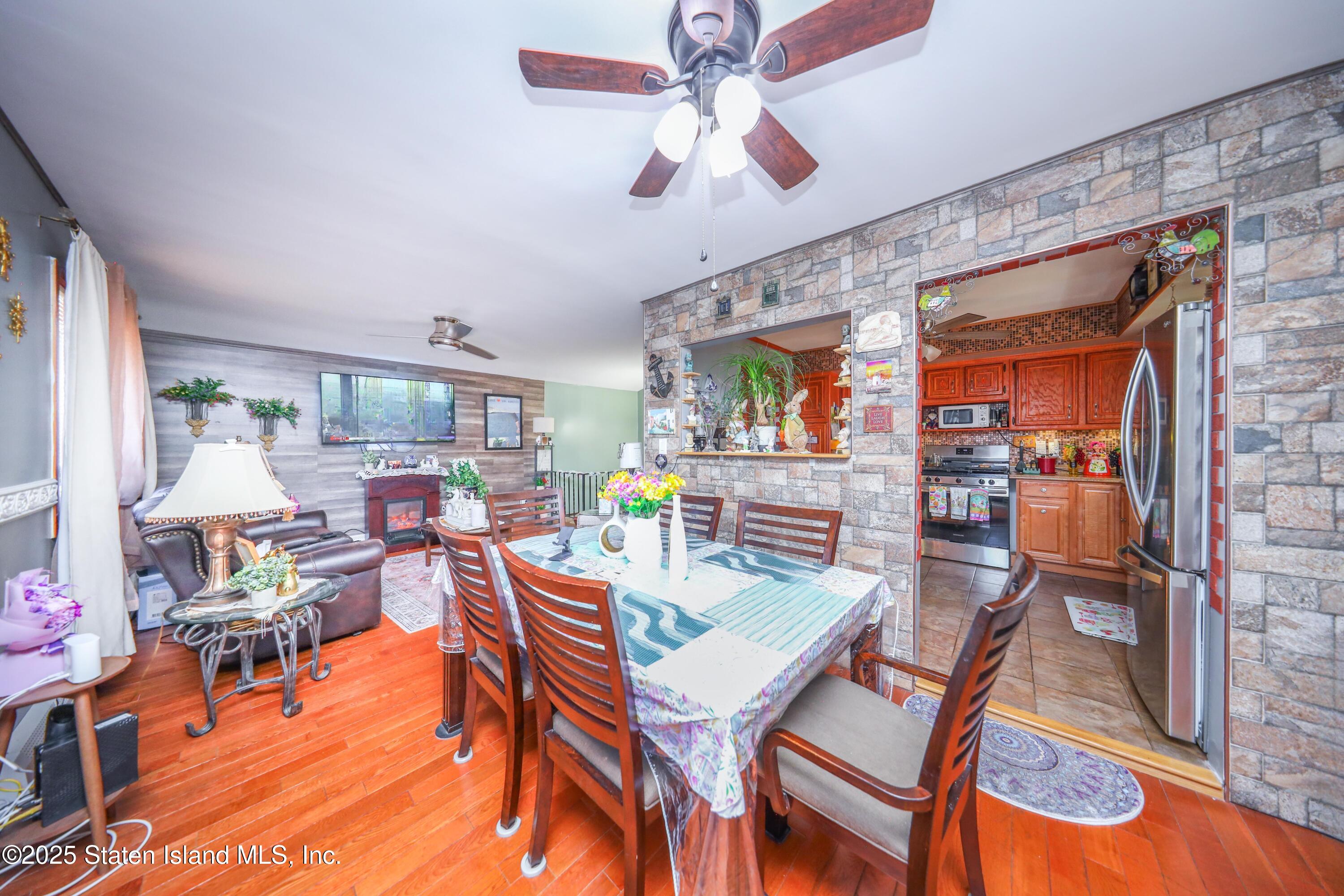 268 Ada Drive Staten Island, NY 10314 - Photo 4 of 27 a dining room with furniture a rug and chandelier