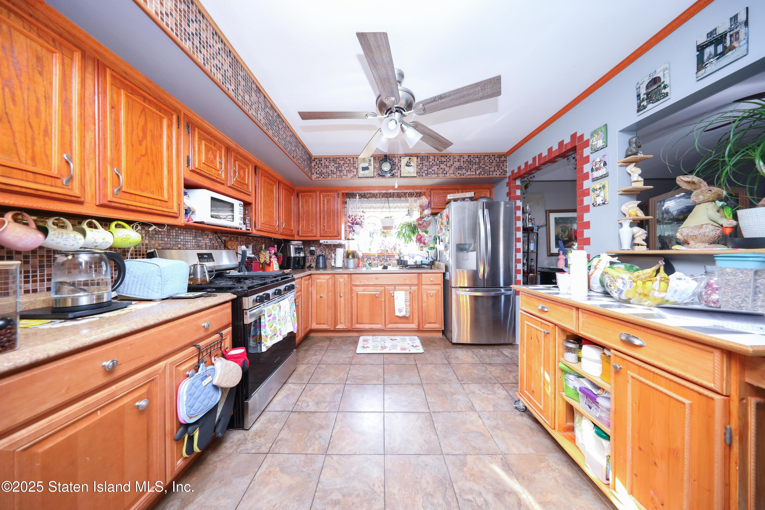 268 Ada Drive Staten Island, NY 10314 - Photo 8 of 27 a large kitchen with stainless steel appliances granite countertop a stove and cabinets