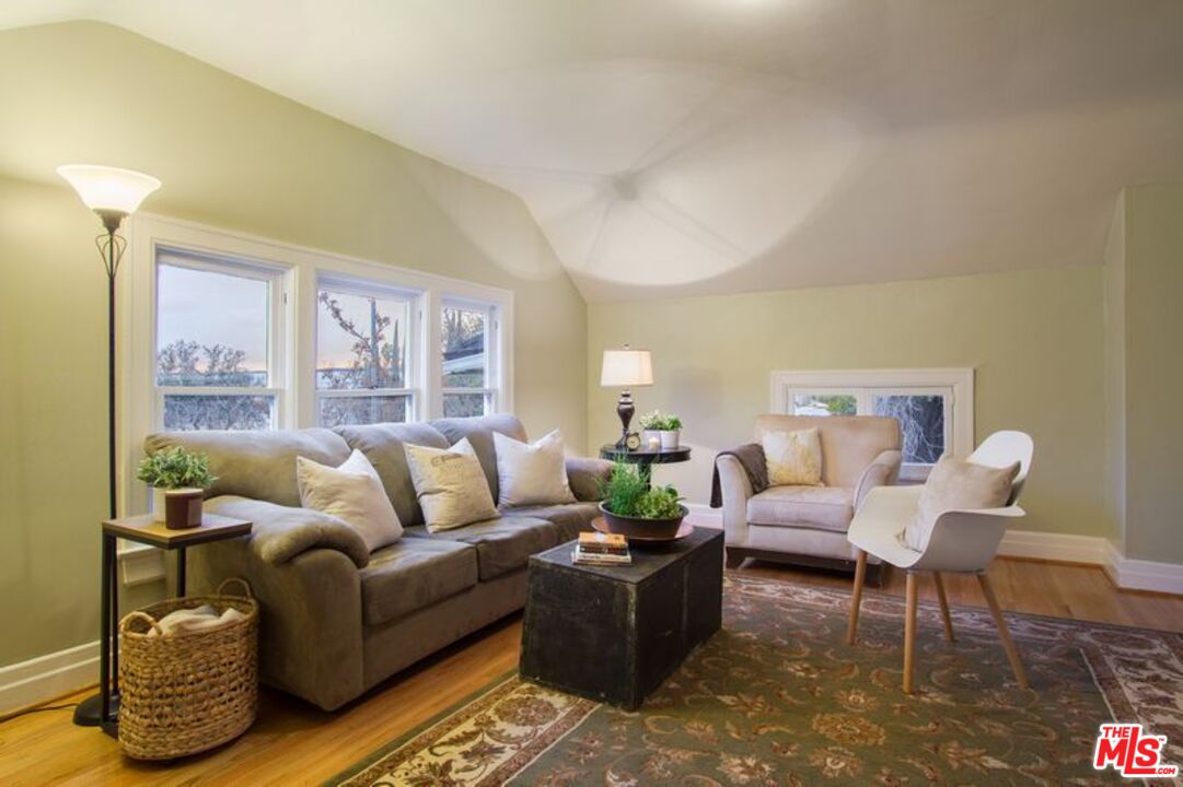 769 North Orange Grove Boulevard Pasadena, CA 91103 - Photo 6 of 6 a living room with furniture and a large window