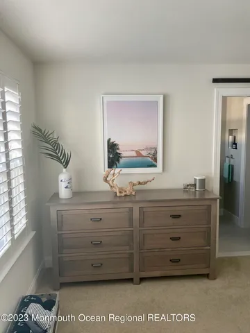 a view of room with cabinet and mirror