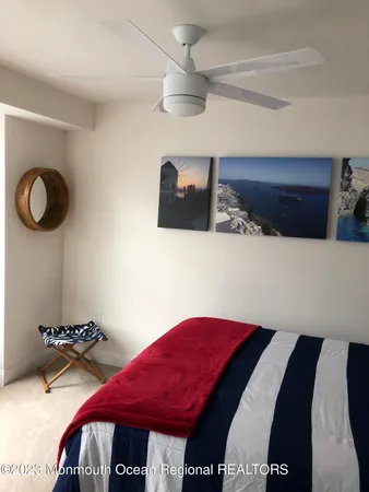 a bedroom with bed and a chandelier