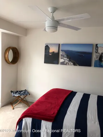 a bedroom with bed and a chandelier