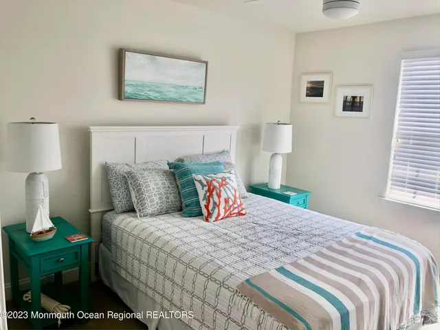 a bedroom with a bed and a night stand