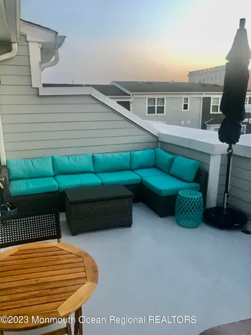 a backyard of a house with barbeque oven and outdoor seating