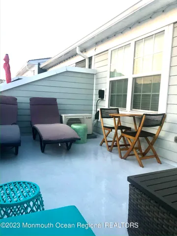 a backyard of a house with table and chairs