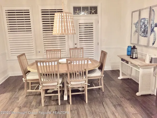 a dining room with furniture and wooden floor