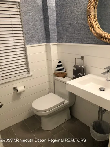 a bathroom with a toilet a sink and a window