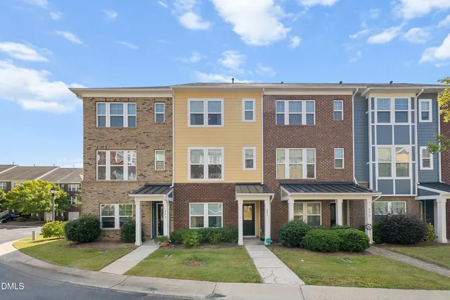 a front view of residential houses with yard
