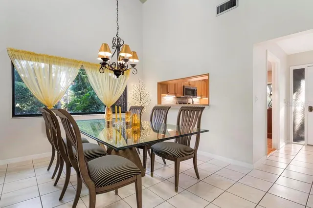 a view of a dining room with furniture wooden floor and chandelier