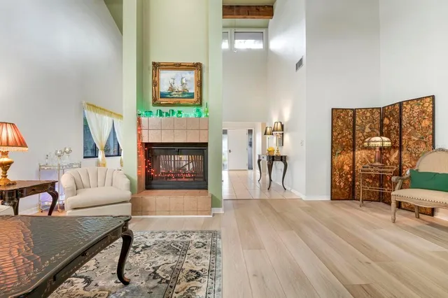 a living room with furniture and a fireplace