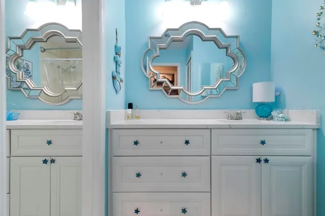 a bathroom with a sink vanity and mirror