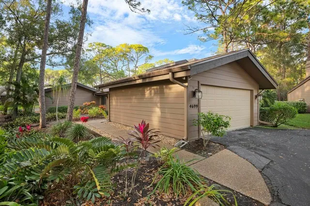 a backyard of a house with flower plants