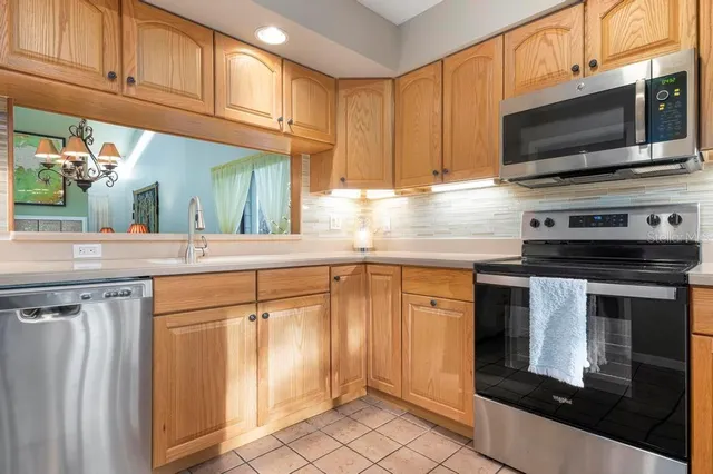 a kitchen with stainless steel appliances granite countertop a stove microwave and sink