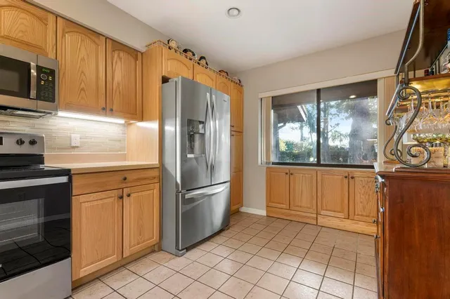 a kitchen with stainless steel appliances granite countertop a refrigerator and microwave