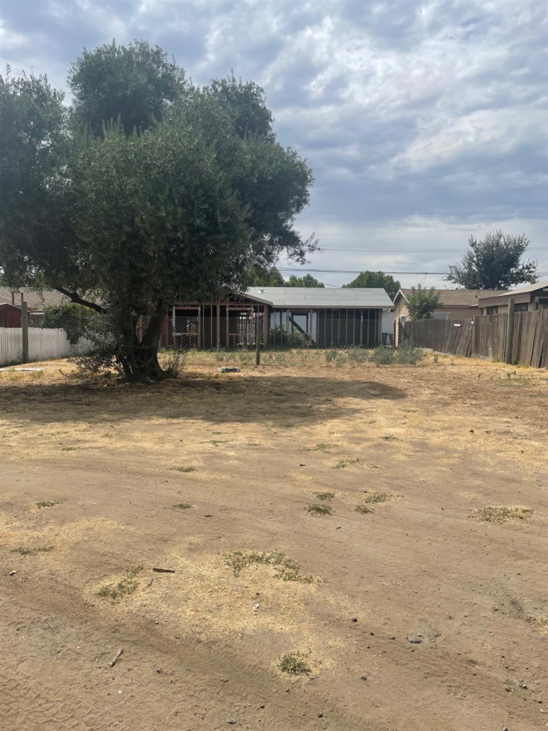 a view of swimming pool with lawn chairs and iron fence