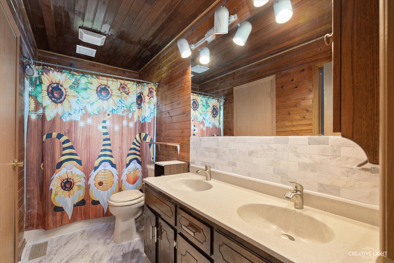 28W758 Wagner Road Naperville, IL 60564 - Photo 8 of 22 a bathroom with a sink a toilet and shower curtain