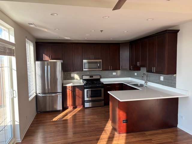 625 Deerfield Road, Unit 419 Deerfield, IL 60015 - Photo 6 of 19 a kitchen with wooden cabinets and stainless steel appliances