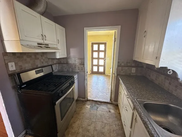 a kitchen that has a sink and a stove