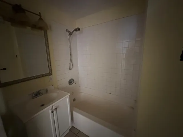 a bathroom with a sink and mirror with toilet