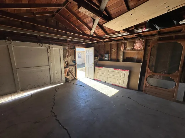 a view of empty room with wooden walls