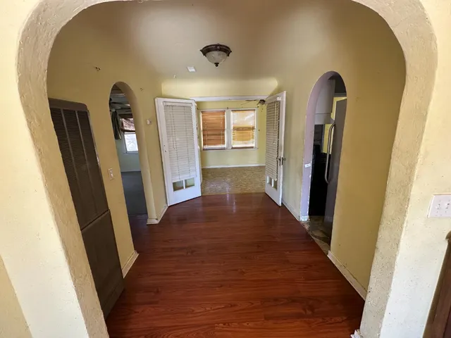 a view of a hallway with wooden floor
