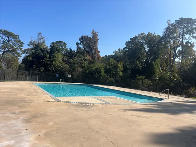 a view of a swimming pool with a yard