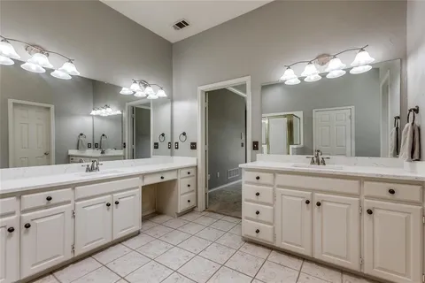 a bathroom with a double vanity sink mirror and a