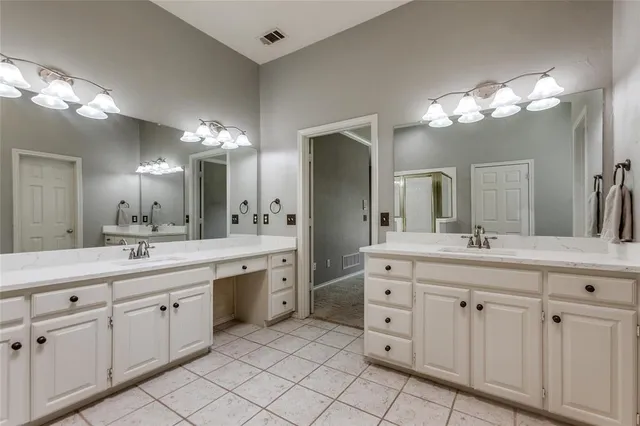 a bathroom with a double vanity sink mirror and a