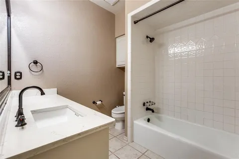 a bathroom with a tub sink and mirror