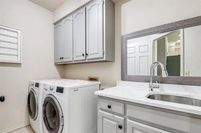 a view of a sink and washer dryer