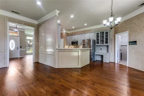 a view of a kitchen and dining room with wooden floor