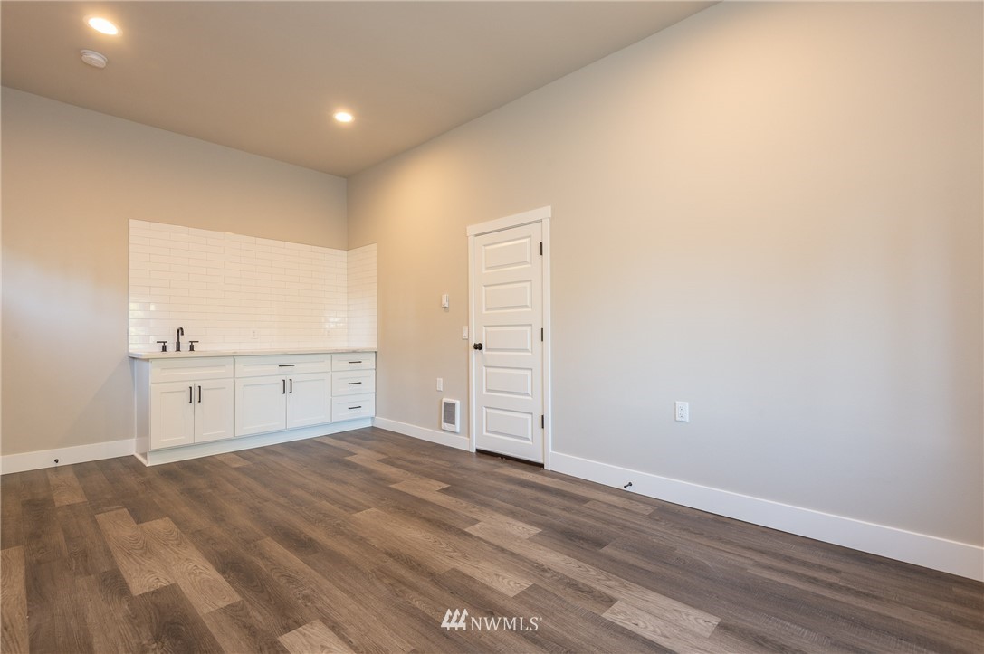 8718 Custer Road Southwest Lakewood, WA 98499 - Photo 22 of 26 an empty room with wooden floor