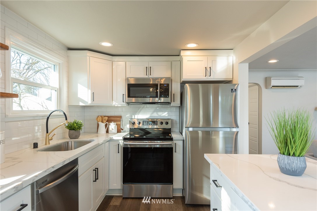 8718 Custer Road Southwest Lakewood, WA 98499 - Photo 8 of 26 a kitchen with a refrigerator and a sink