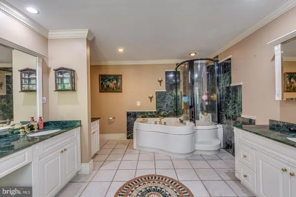 a bathroom with a sink a large mirror and a bathtub