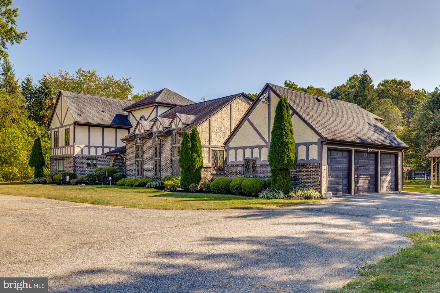 740 Garwood Road Moorestown, NJ 08057 - Photo 2 of 41 Elegant Tudor-style home with lush landscaping.