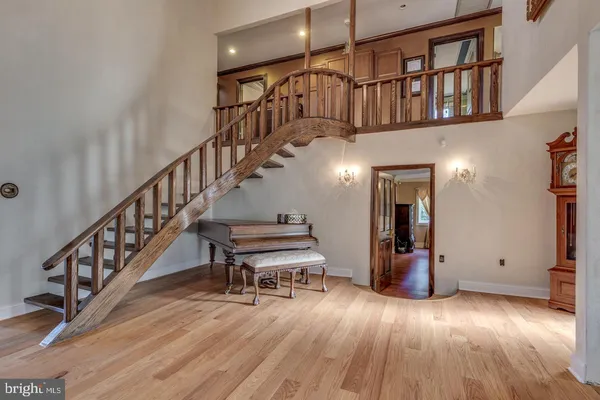 a view of entryway and hall with wooden floor