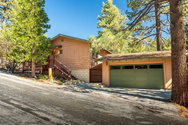 a view of a house with a yard and garage
