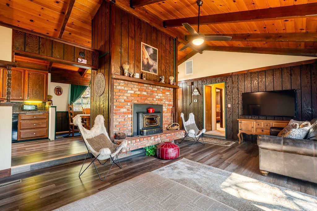 25580 Fir Street Idyllwild, CA 92549 - Photo 11 of 48 a living room with furniture a flat screen tv and floor to ceiling window